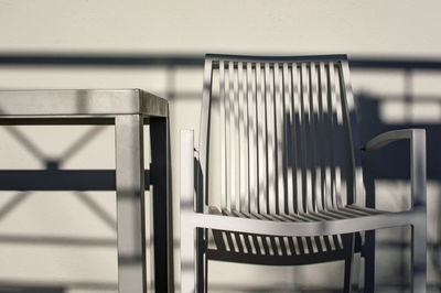 Close-up of empty chair against wall 