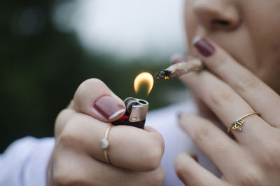 Close-up of hand holding cigarette