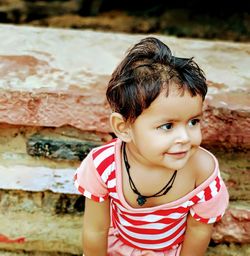 Close-up of cute smiling girl looking away