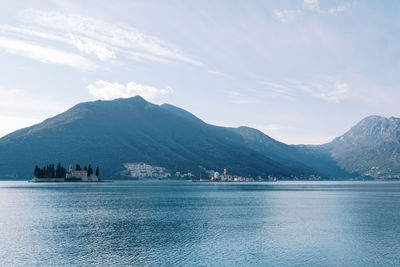 Scenic view of sea and mountains against sky