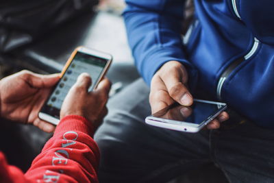 Midsection of man using mobile phone
