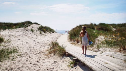 Full length of woman standing on landscape