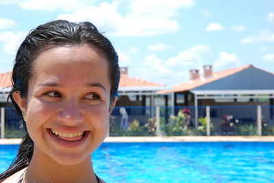 Portrait of smiling young woman in swimming pool