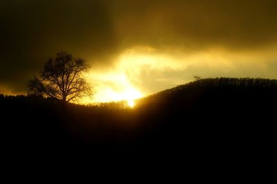 Silhouette of landscape against dramatic sky