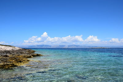 Scenic view of sea against blue sky