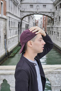Portrait of man looking at canal