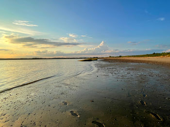 Scenic view of beach against sky during sunset