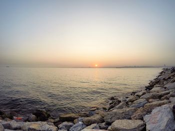 Scenic view of sea against clear sky during sunset