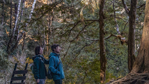 Portrait of woman standing in forest