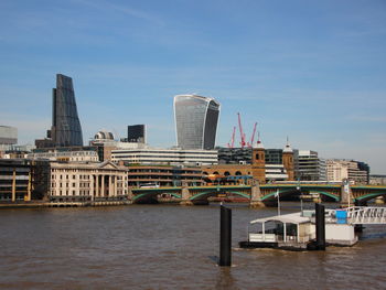 Southwark bridge over thames river against sky