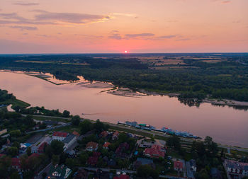 High angle view of townscape by sea against sky