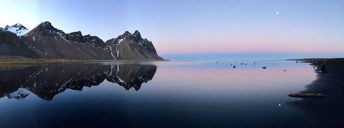 Scenic view of calm lake against blue sky