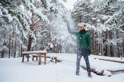 Man standing on snow covered field