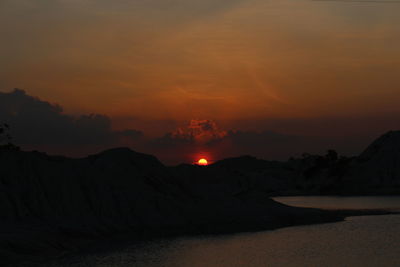 Scenic view of silhouette mountains against sky during sunset