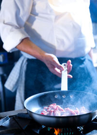 Midsection of man preparing food