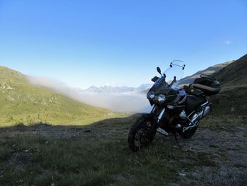 Motorcycle on mountain against sky