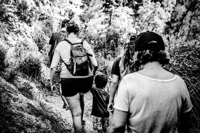 Woman standing on tree trunk