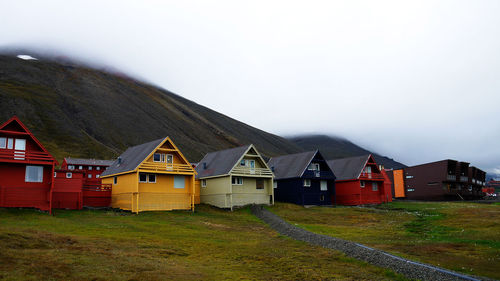 Houses on field against sky