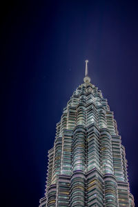 Low angle view of illuminated building against sky at night