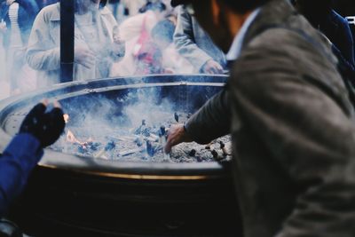 Midsection of man preparing food