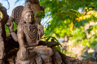 Traditional stone sculpture of hindu god shiva. interior detail from a hotel resort. bali, indonesia