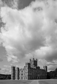 Buildings in city against cloudy sky