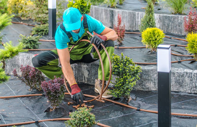 Rear view of woman standing by plants