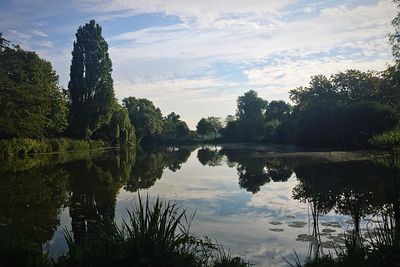 Scenic view of lake against cloudy sky