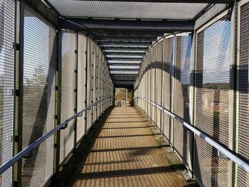 Empty footbridge on sunny day