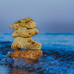 Close-up of stack of stones on beach