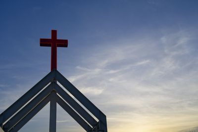 Low angle view of cross against blue sky