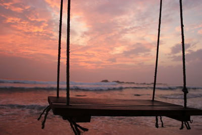 Close-up of boat against sky at sunset