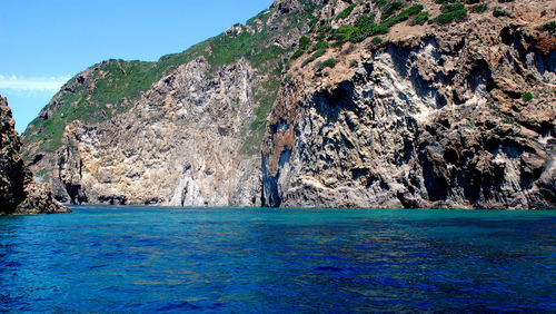 Scenic view of sea against rock formation