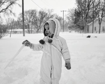 Young woman standing in snow