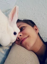 Close-up portrait of young woman with cat