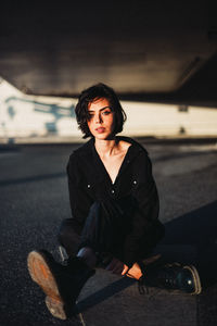 Portrait of young woman sitting in car