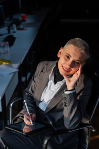 Portrait of smiling young man using mobile phone