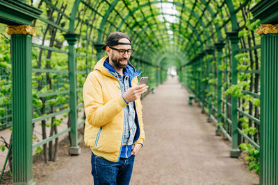 Full length of man using mobile phone