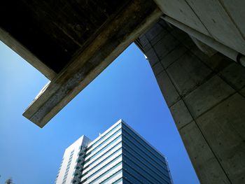 Low angle view of skyscrapers against clear blue sky