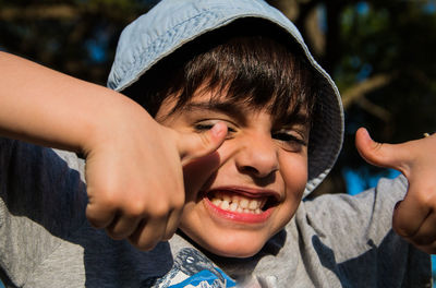 Portrait of smiling boy gesturing thumbs up