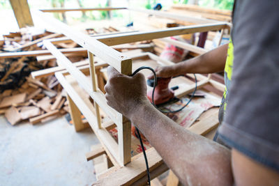 Midsection of man working in factory