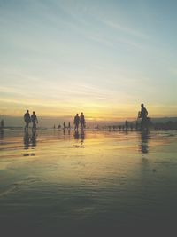 People on beach at sunset