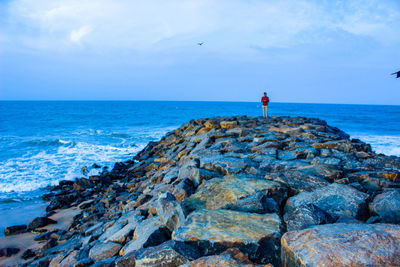 Scenic view of rocks on beach against sky