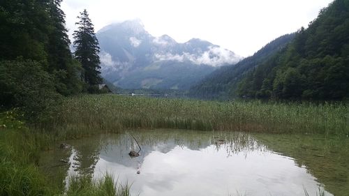 Scenic view of lake and mountains against sky