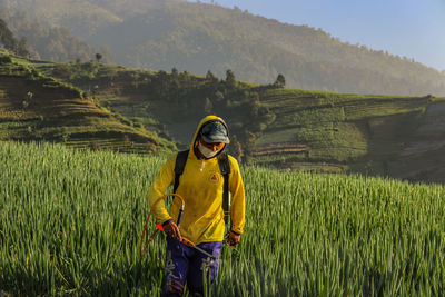 Full length of man standing on field