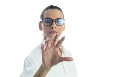 Portrait of man wearing eyeglasses against white background