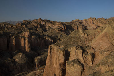 Scenic view of rocky mountains against clear sky