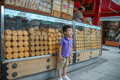 Full length of boy looking away in store