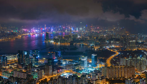 High angle view of city lit up at night