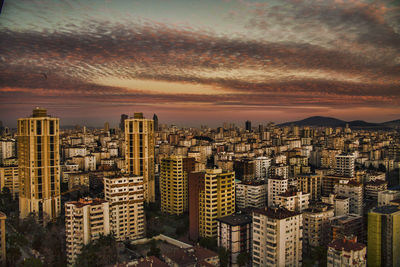 High angle view of crowded cityscape at sunset